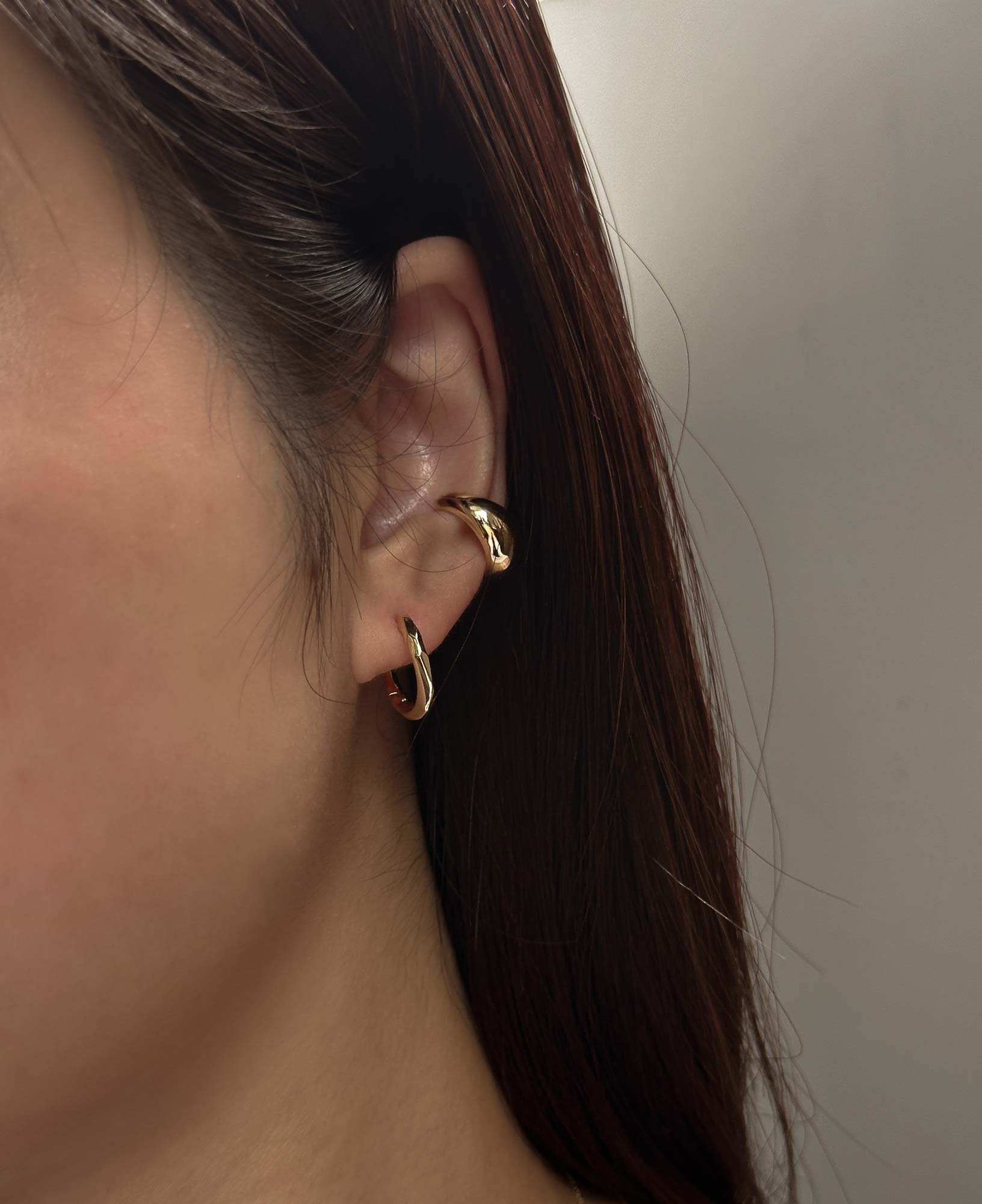 model shot of rachel twist hoop earrings and betsy chunky ear cuff 