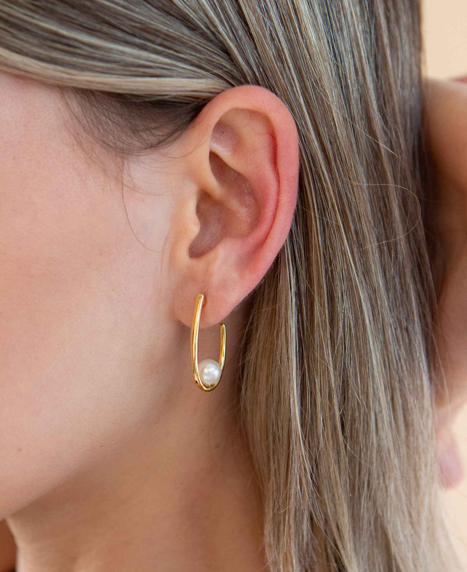 Side angle shot of model wearing the aurelie pearl hoop earrings