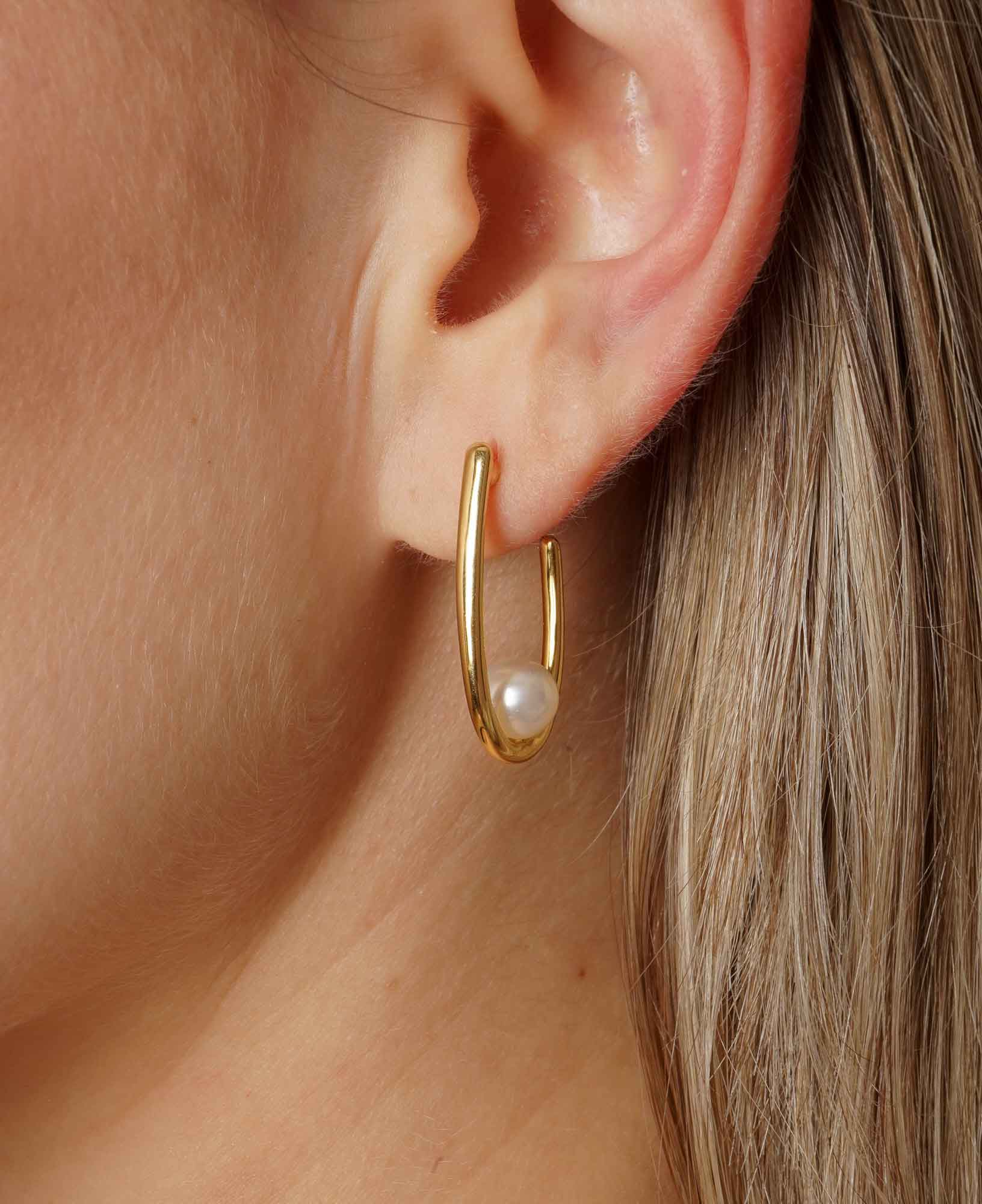 close up detail shot of model wearing aurelie pearl hoop earrings 