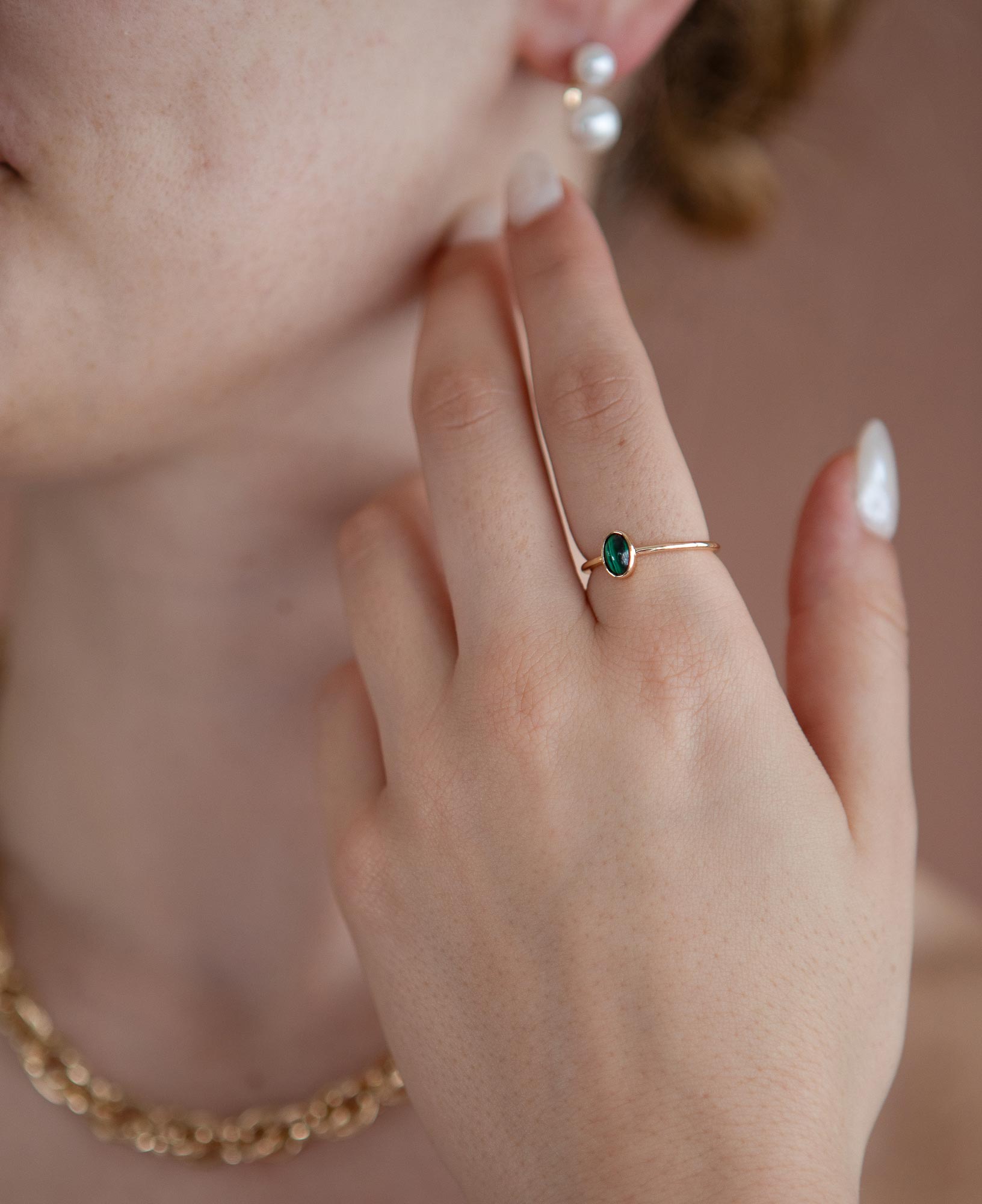close up model shot of jane malachite bezel ring, young pearl jacket earrings and emma chunky chain gold necklace