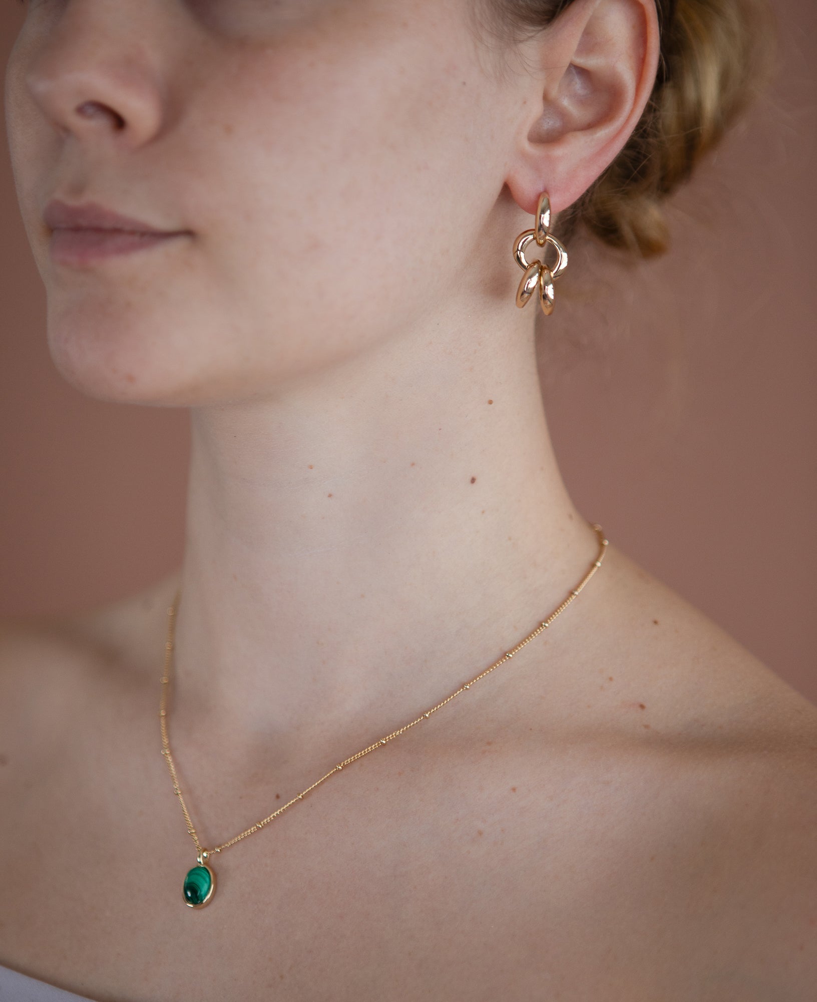 model shot of haru malachite bezel necklace and hannah interchangeable gold hoop earrings