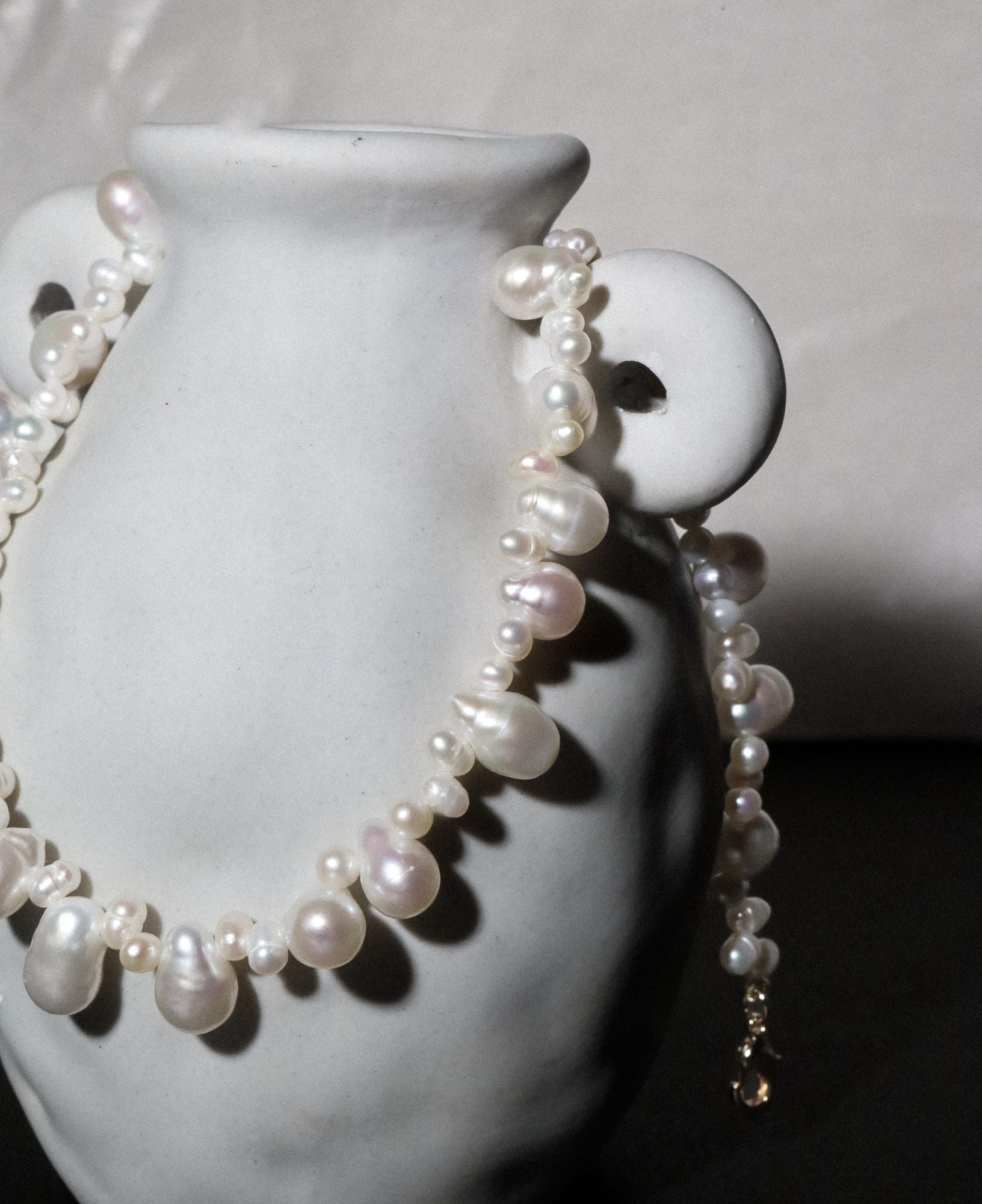 close-up of an artistic lifestyle shot of the Isla Teardrop Baroque Pearl Choker Necklace