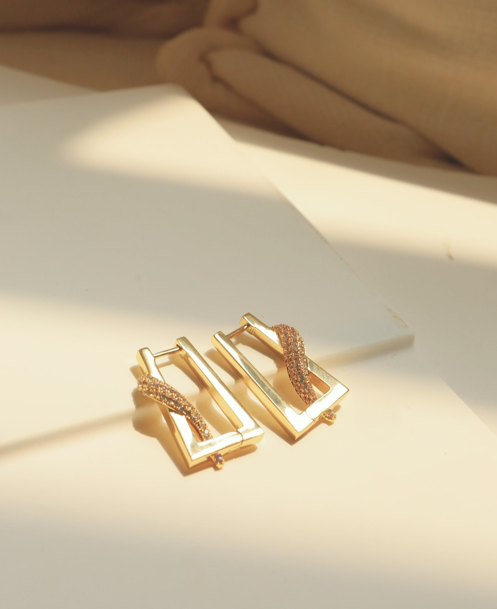 flat lay product shot of the Kim CZ Pave Rectangle Hoop Earrings