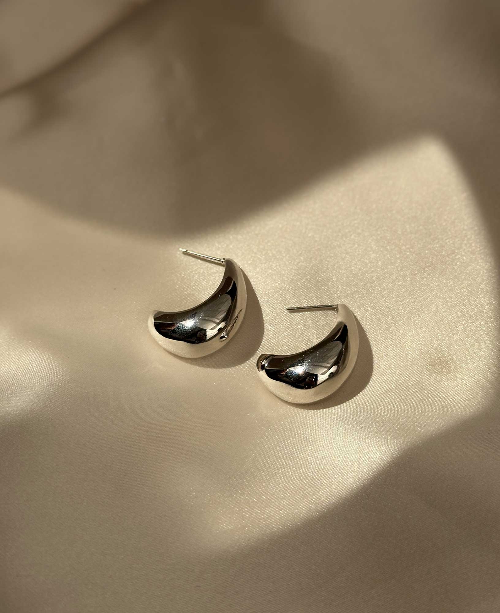 lifestyle shot of agathe rhodium plated statement earrings