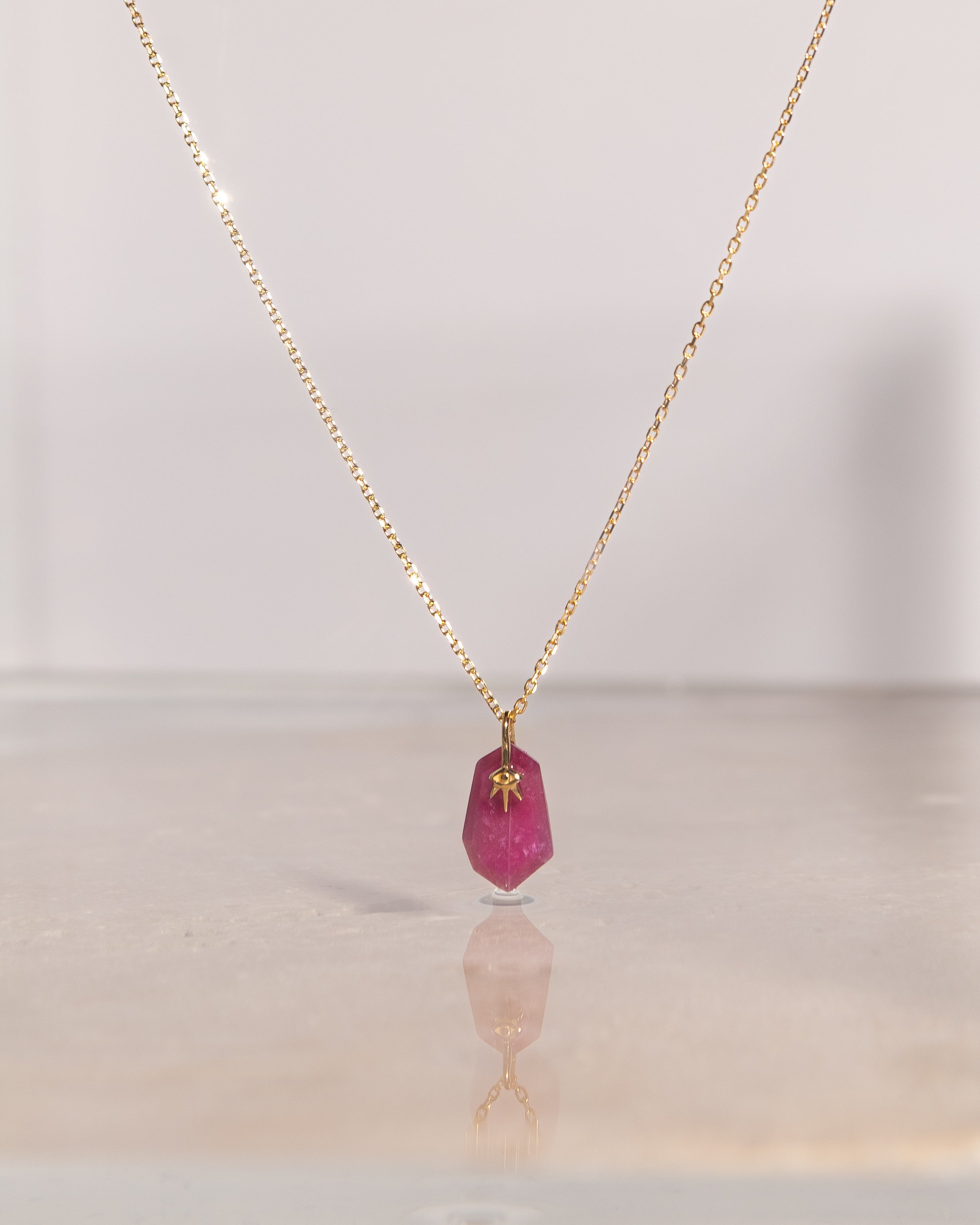 lifestyle product shot of sienna ruby 14k solid gold necklace