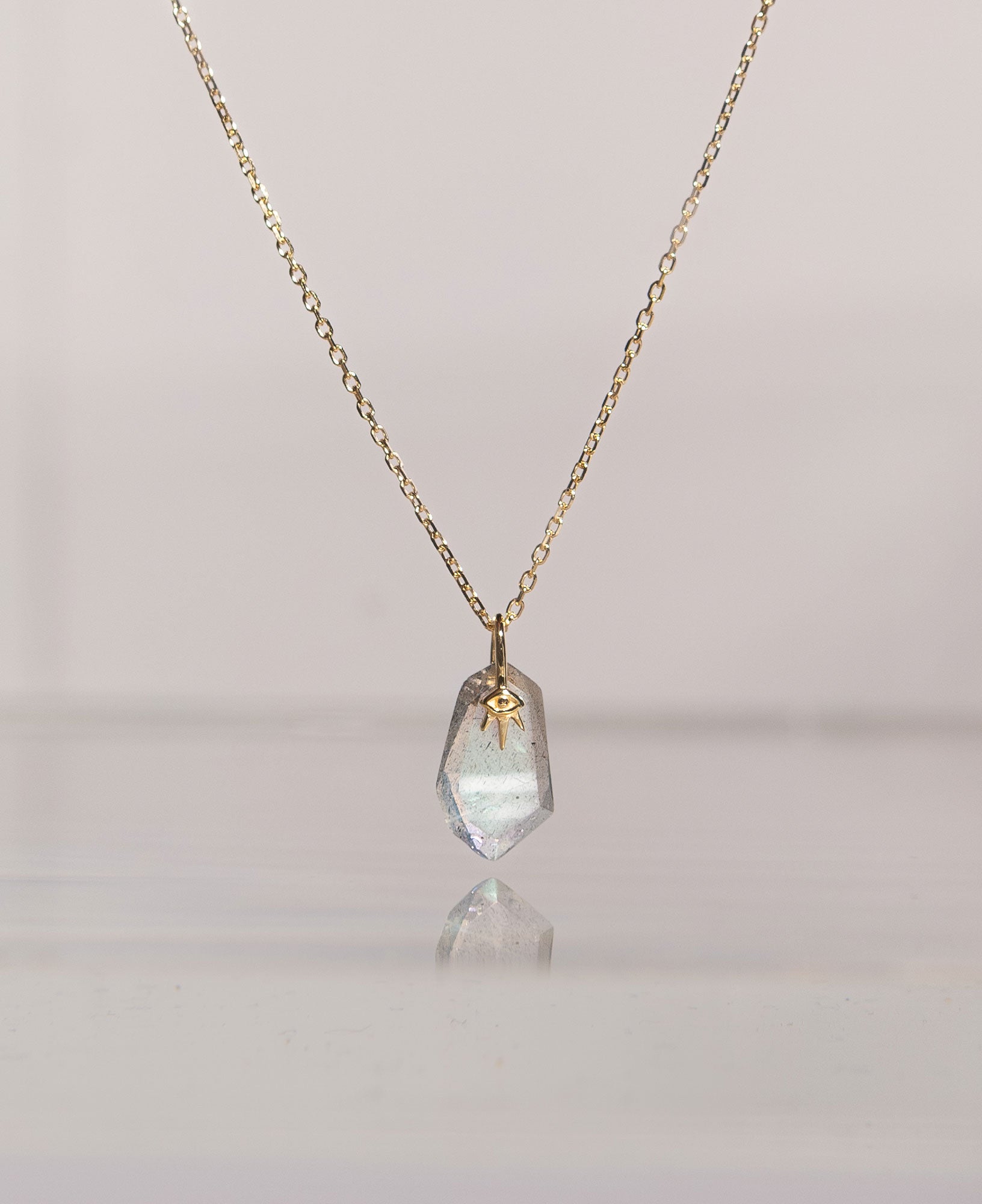 lifestyle product shot of calypso 14k solid gold necklace