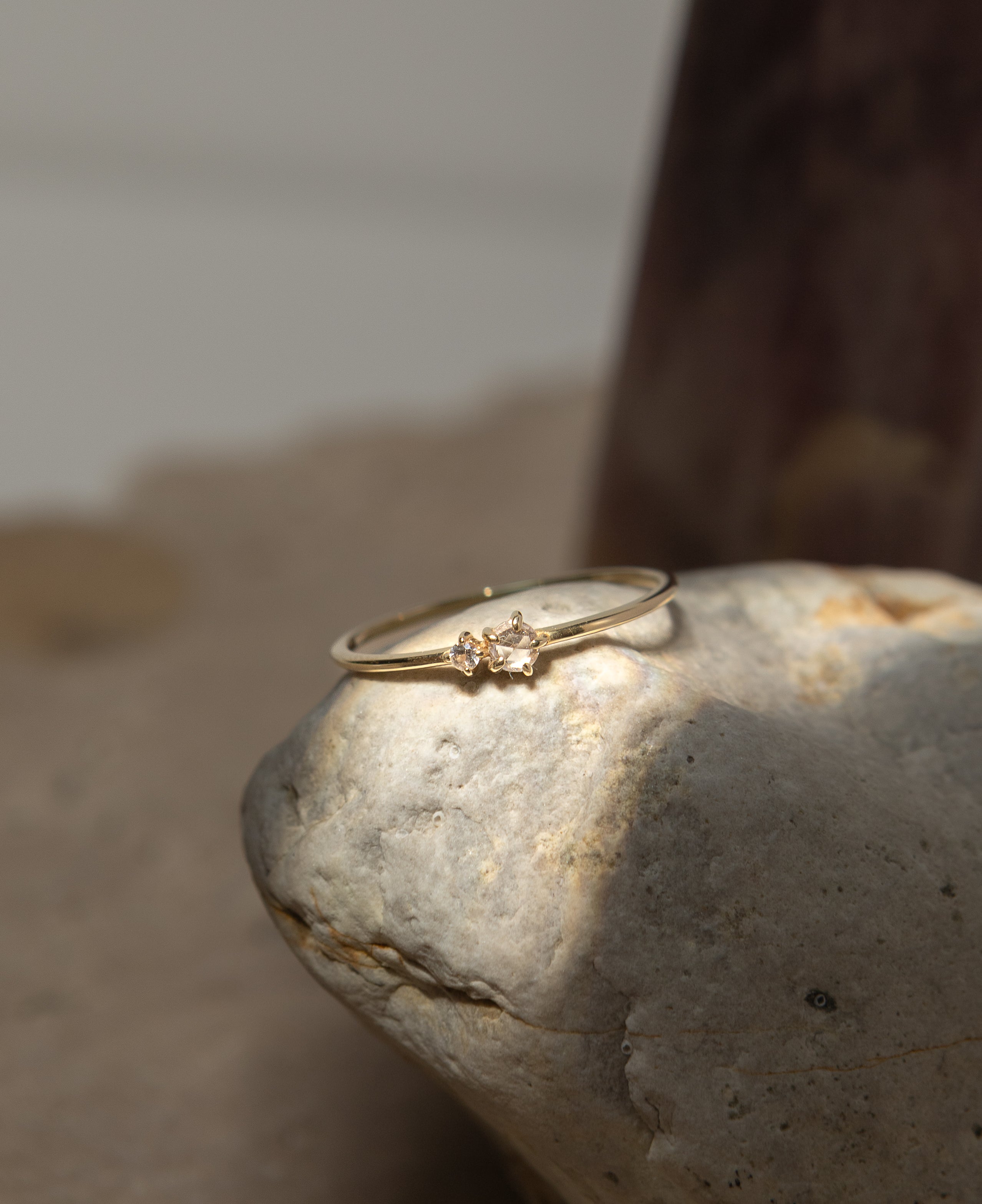 lifestyle product shot of ophelia white sapphire solid gold ring