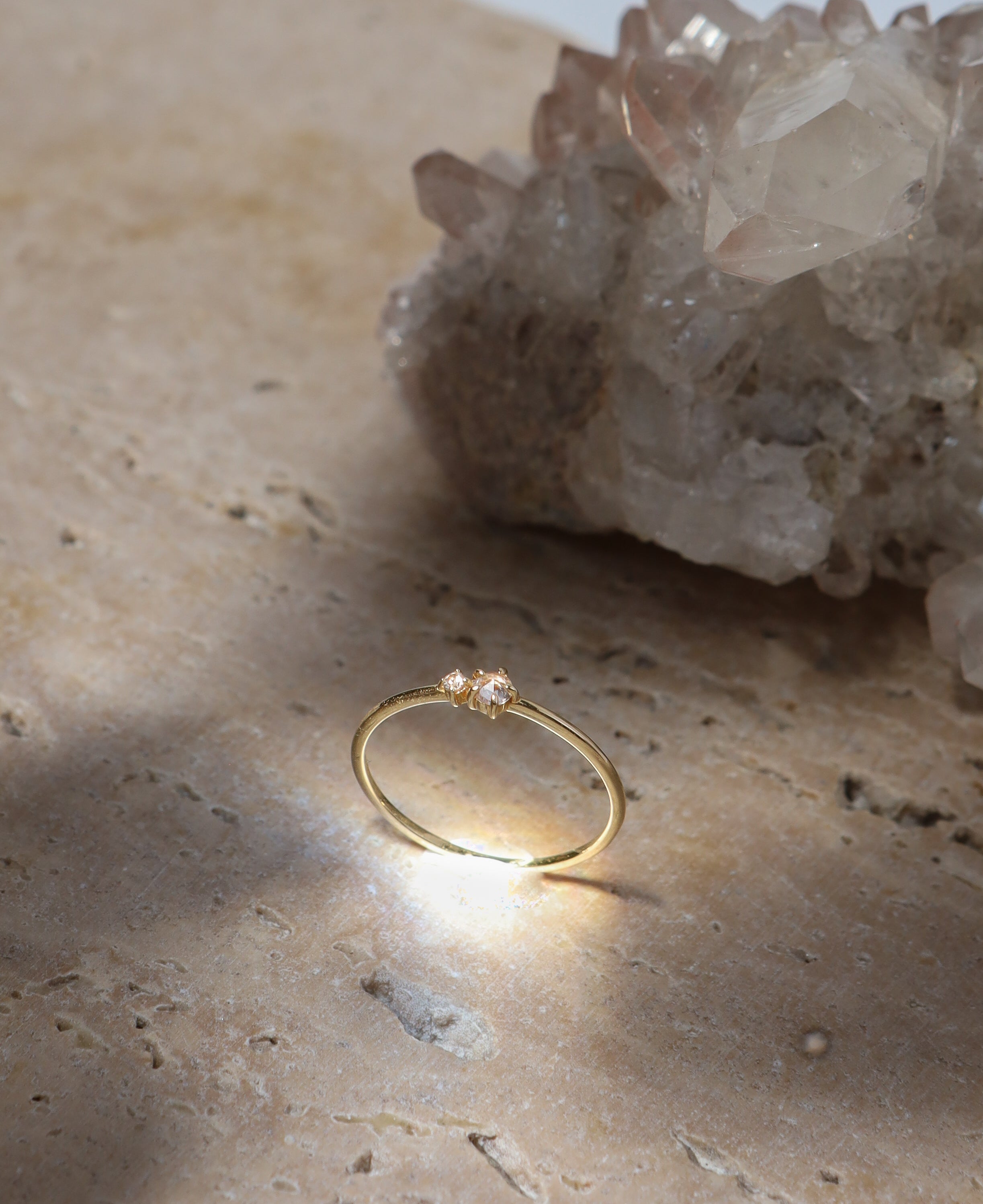 lifestyle product shot of ophelia white sapphire solid gold ring