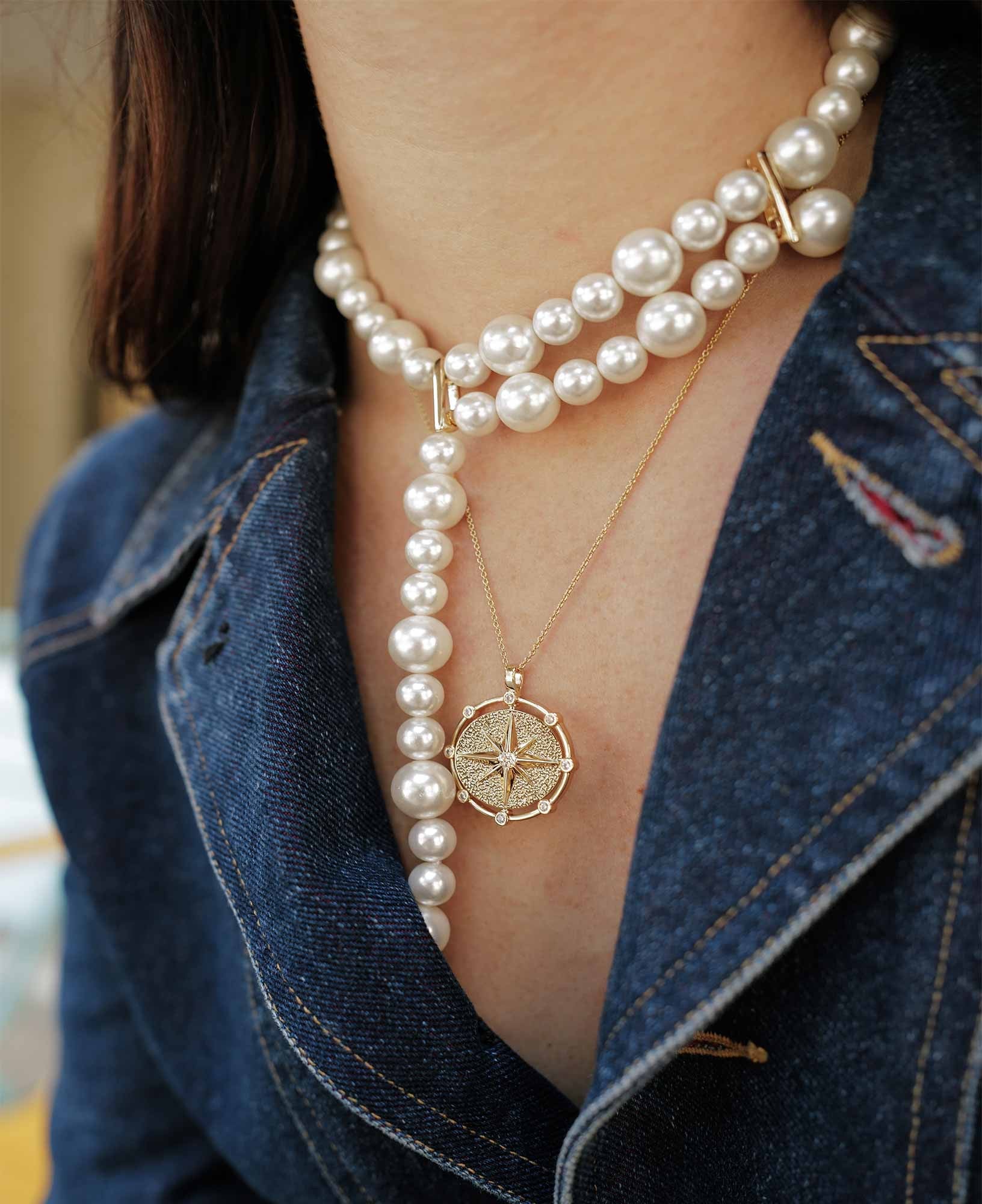 model shot of purpose compass pendant necklace and chamani pearl choker necklace