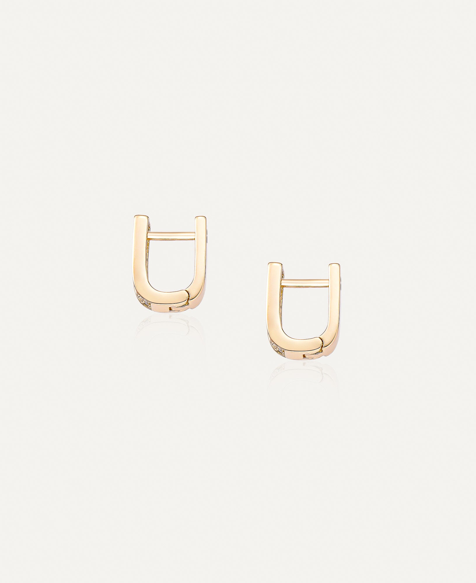 Side view of Paloma Reversible CZ Huggie Hoop Earrings.