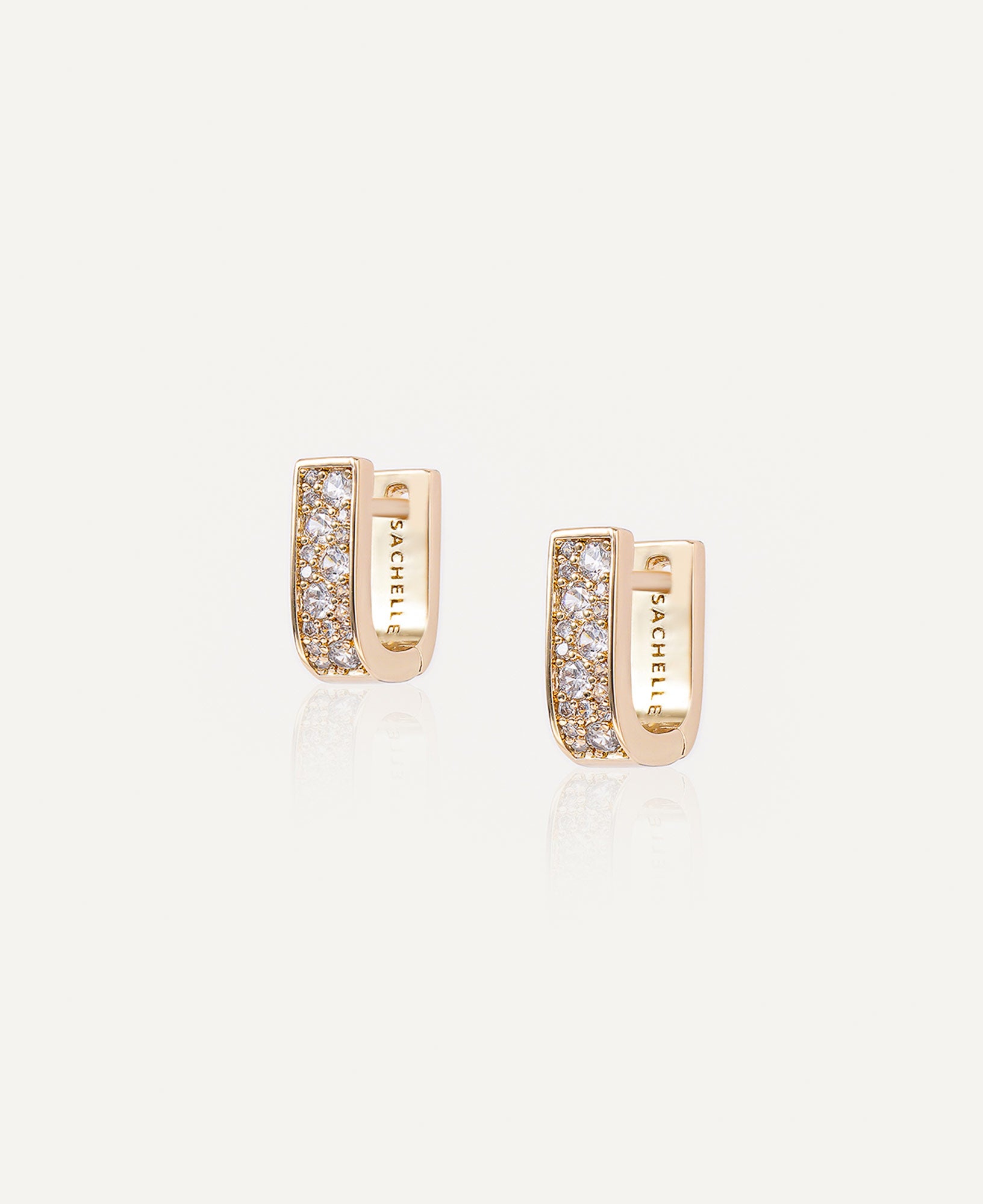 Product picture of Paloma Reversible CZ Huggie Hoop Earrings.