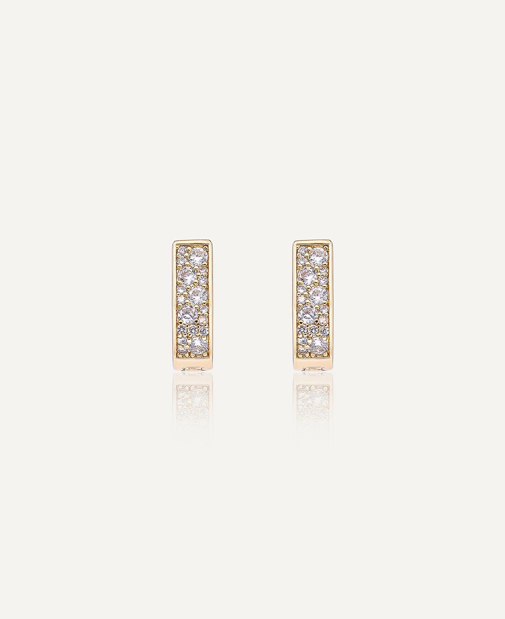 Product picture of Paloma Reversible CZ Huggie Hoop Earrings.