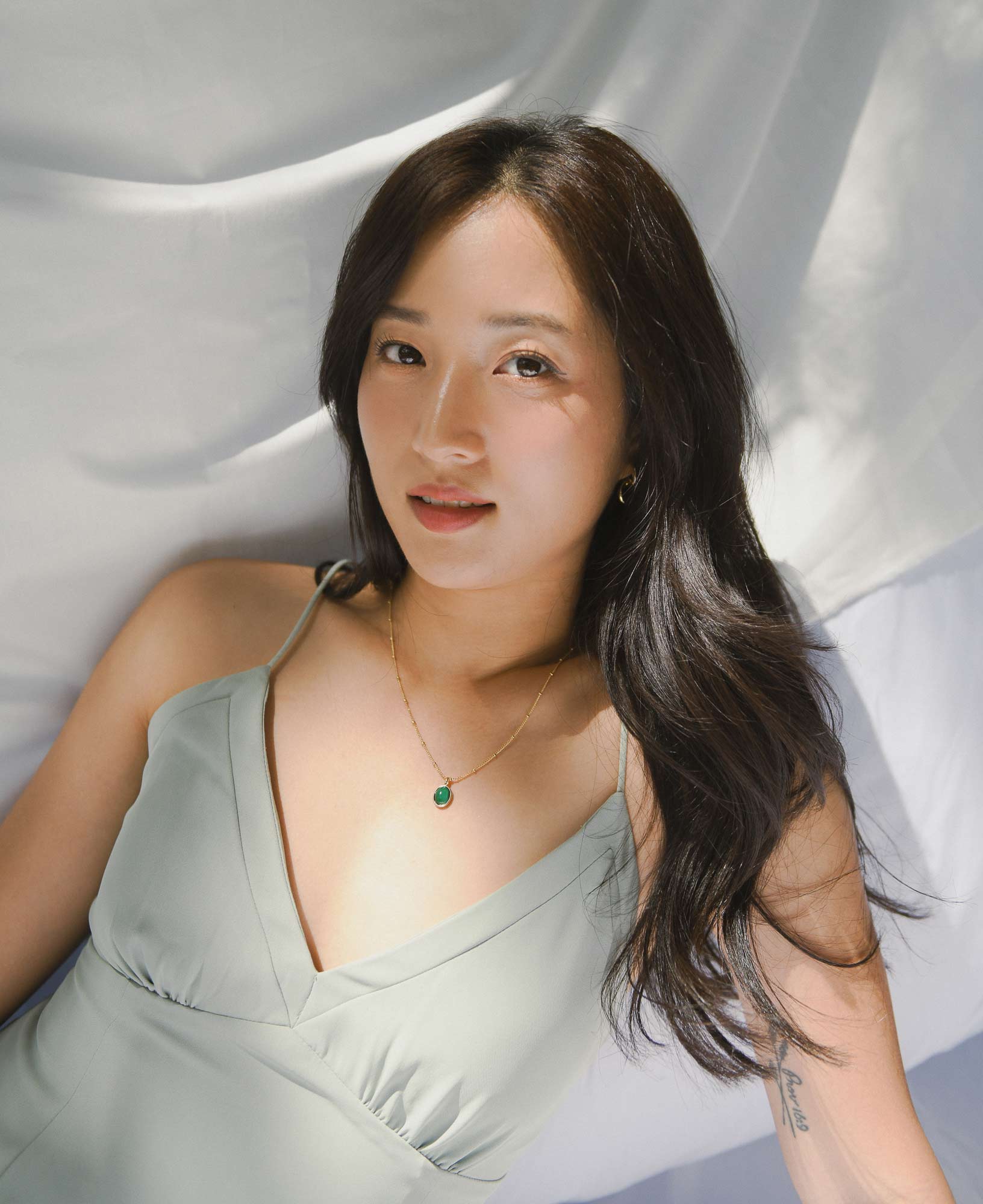 model shot of Sally Kim wearing the Haru Malachite Bezel Necklace