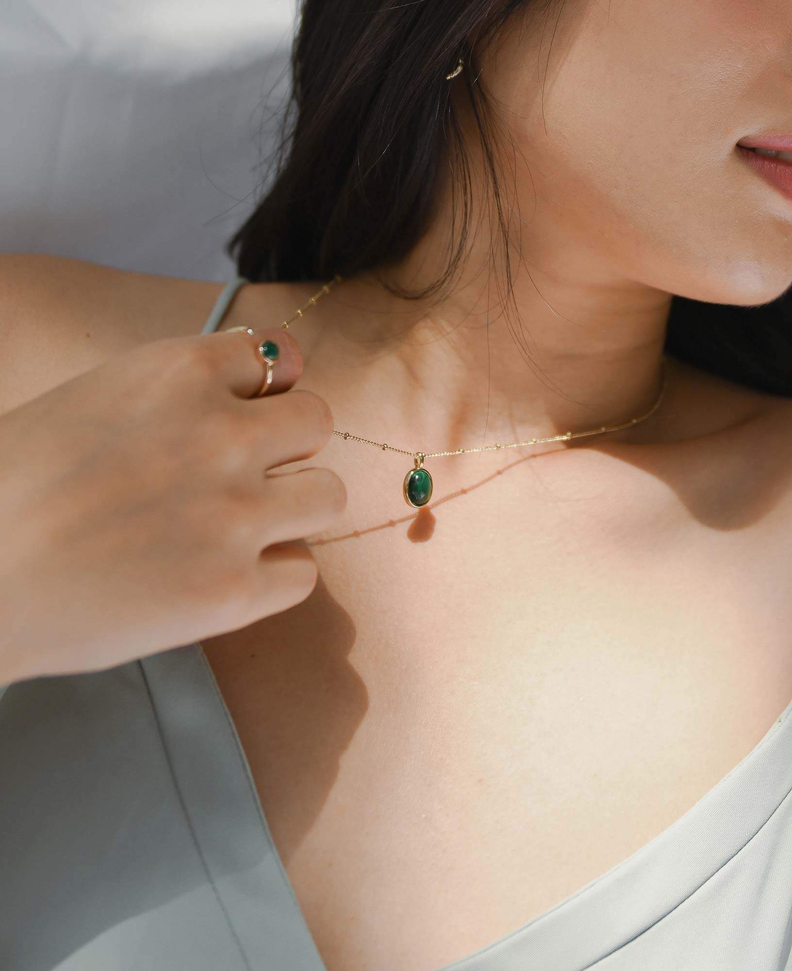 model shot of Sally Kim wearing the Haru Malachite Bezel Necklace and the Jane Malachite Bezel Ring