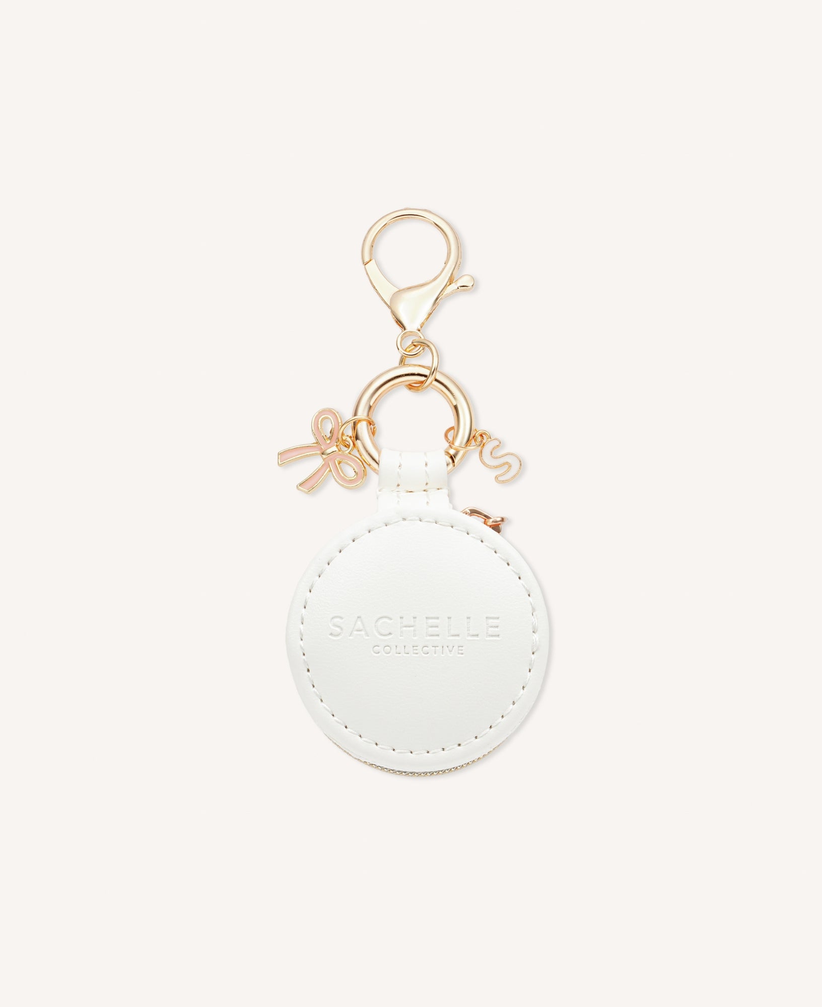 Close-up of a stylish Sachelle Collective bag charm, showcasing intricate details and quality craftsmanship, featuring pink ribbon - one of the three charm options.