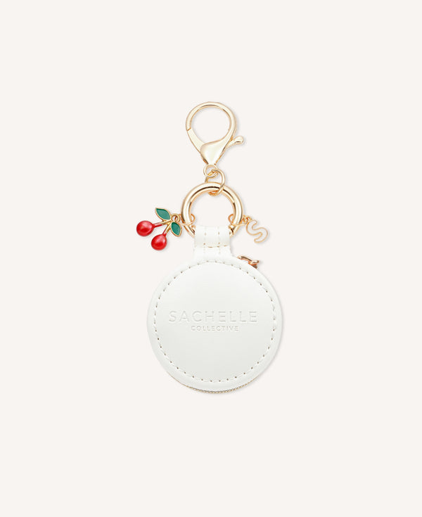 Close-up of a stylish Sachelle Collective bag charm, showcasing intricate details and quality craftsmanship, featuring red cherry - one of the three charm options.
