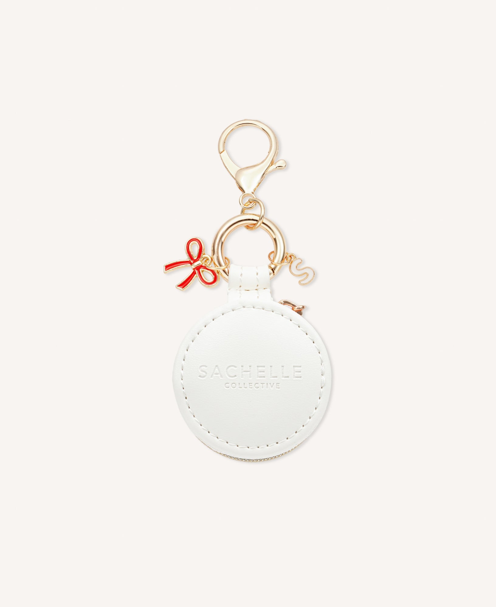 Close-up of a stylish Sachelle Collective bag charm, showcasing intricate details and quality craftsmanship, featuring red ribbon - one of the three charm options.