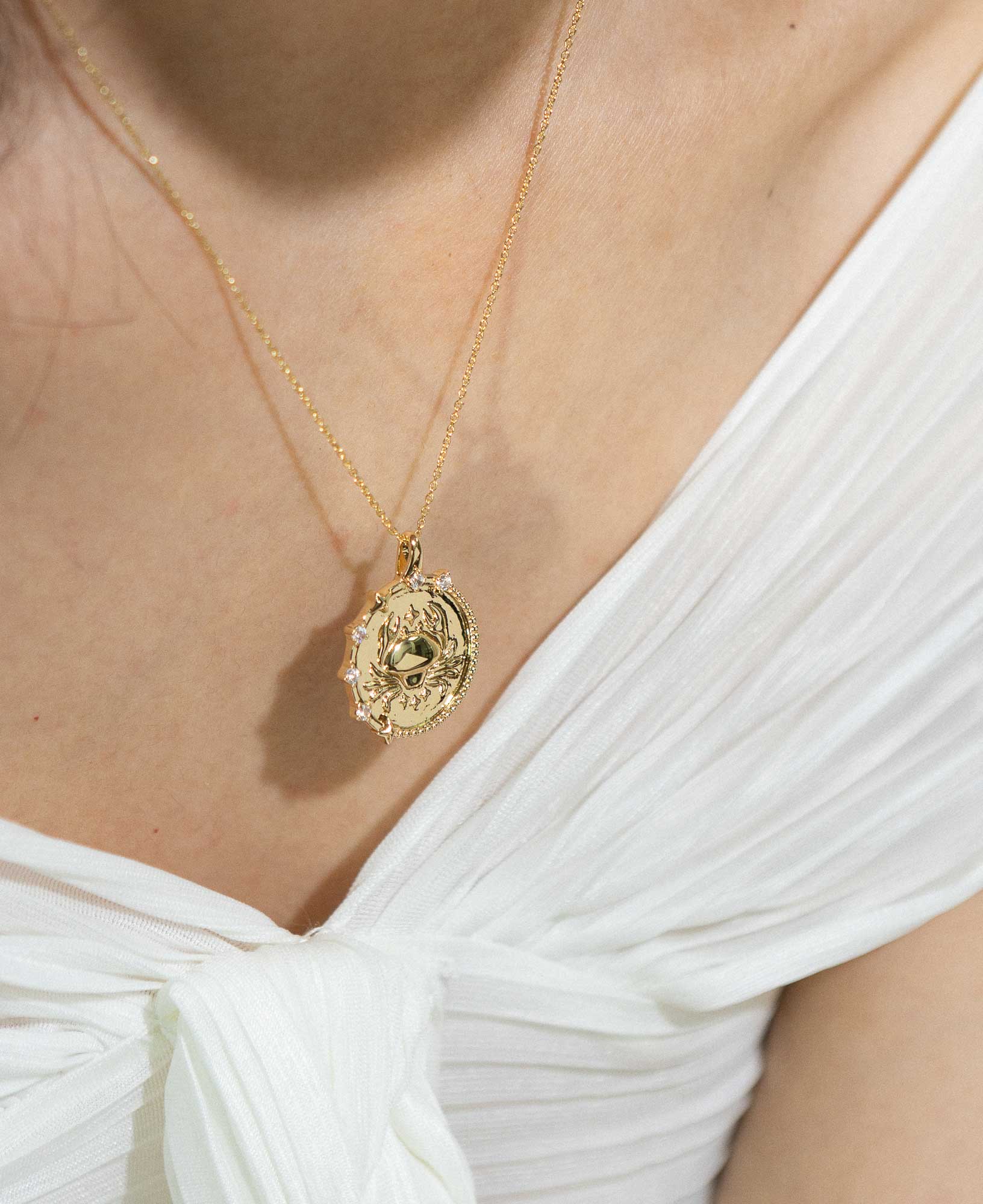 styling the cancer horoscope gold pendant necklace on a model.