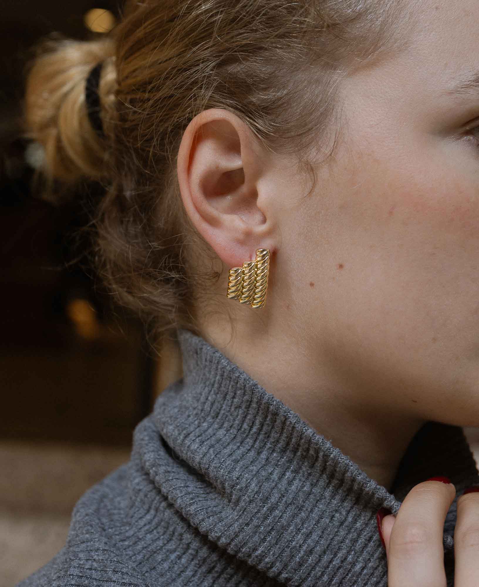 close-up shot featuring the Catherine Rope Link Textured Gold Clip Earrings.