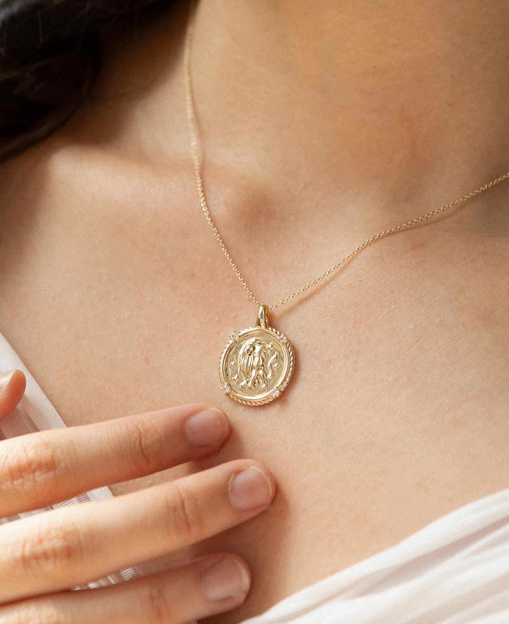 styling the leo horoscope gold pendant necklace on a model.