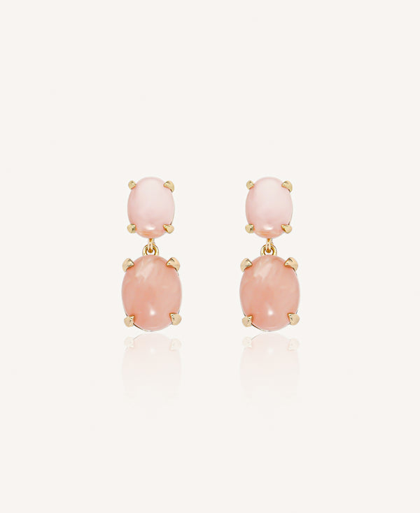 Pair of gold drop earrings with pink opal stones on a plain white background