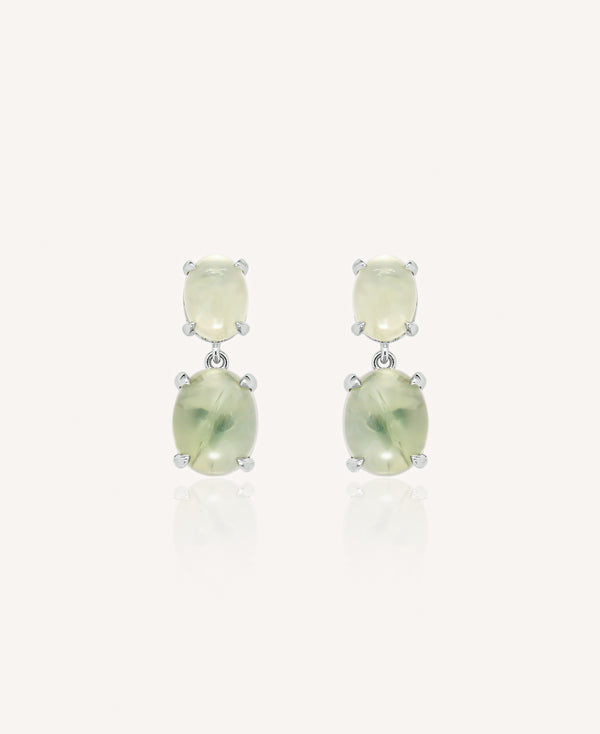 Pair of drop earrings with green gemstones on a white background