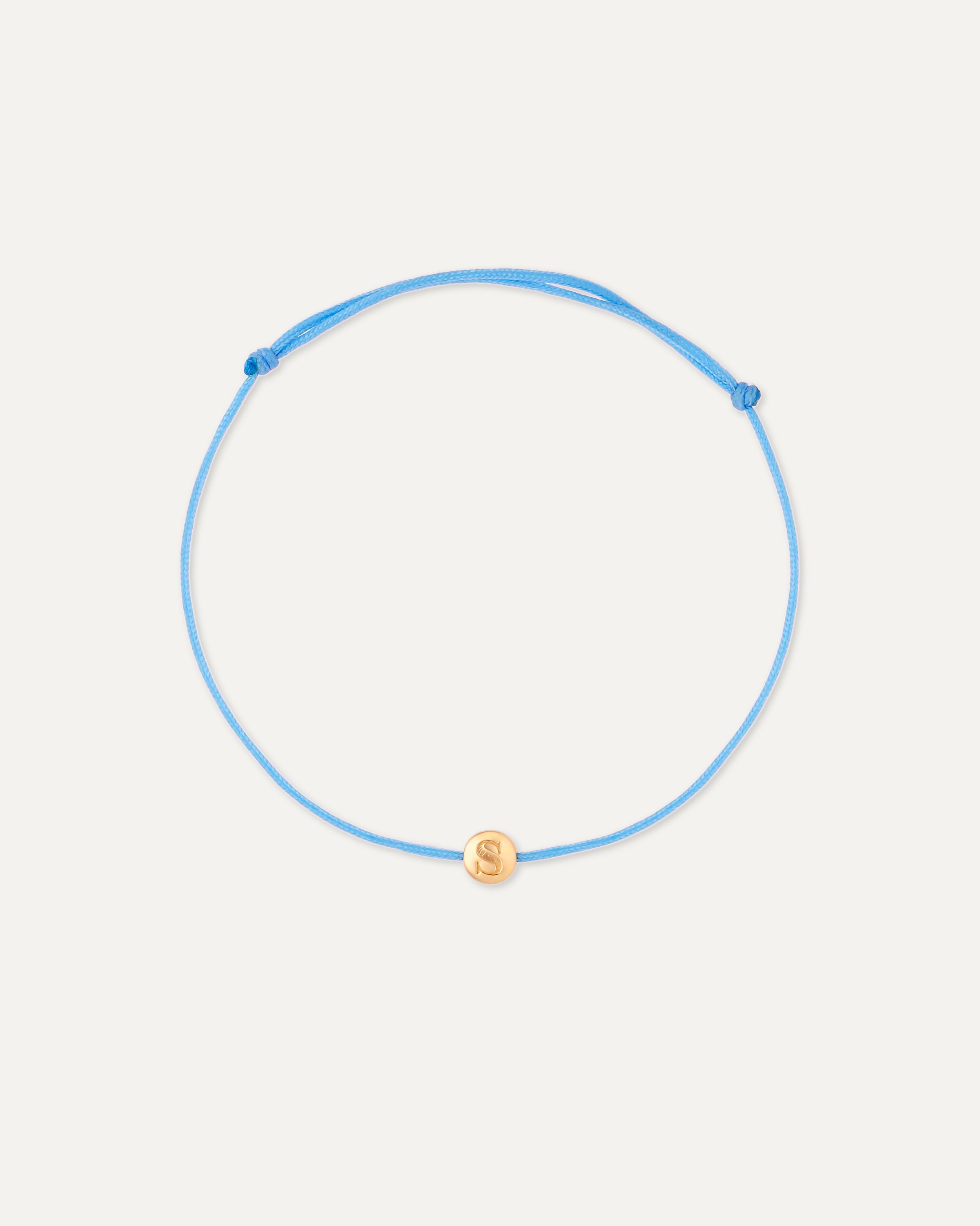 Blue adjustable bracelet with a gold charm on a white background