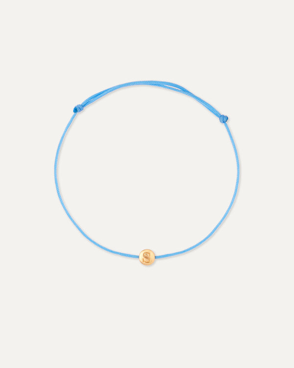 Blue adjustable bracelet with a gold charm on a white background