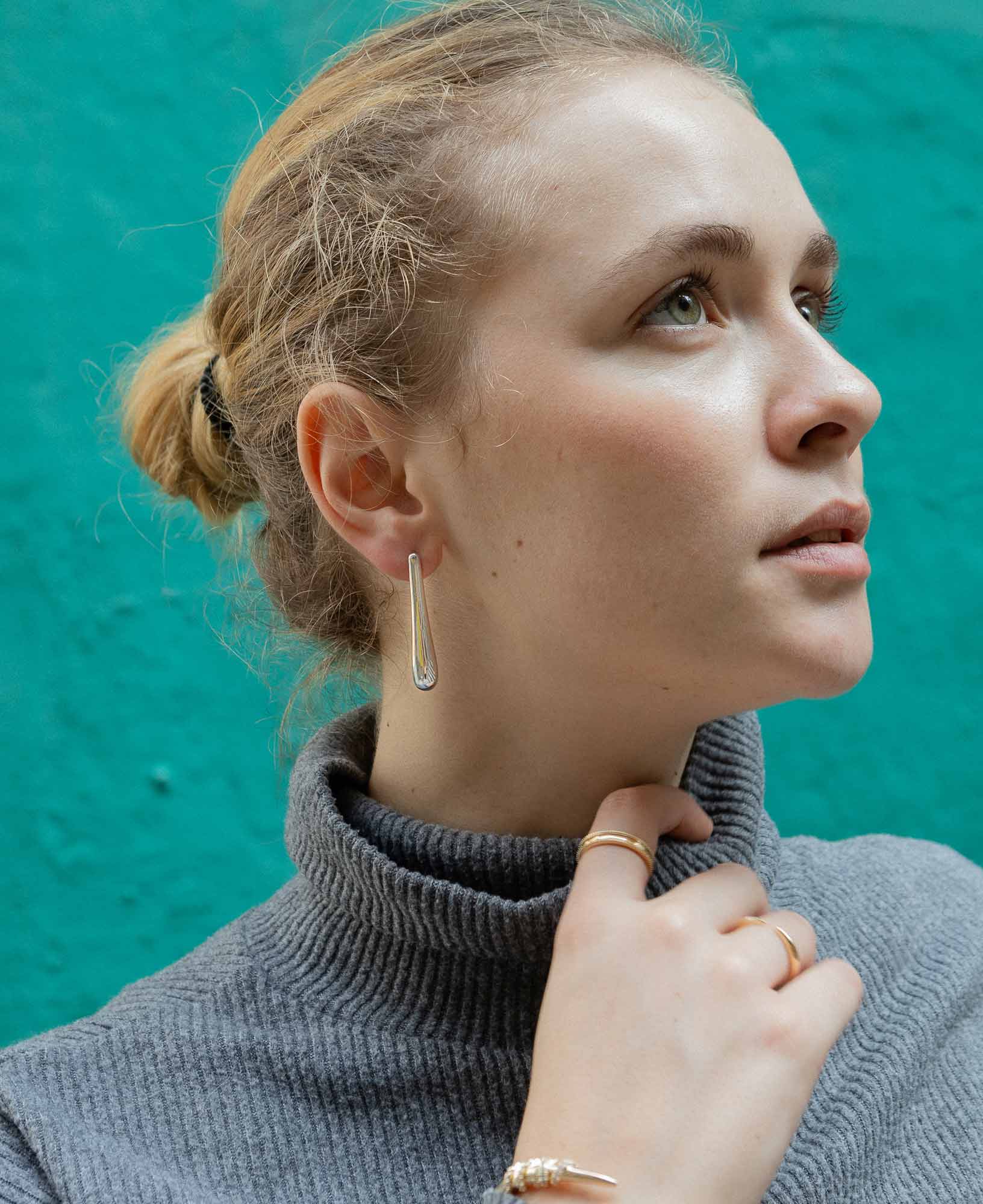 close-up shot featuring the Sybil Silver Droplet Stud Earrings.