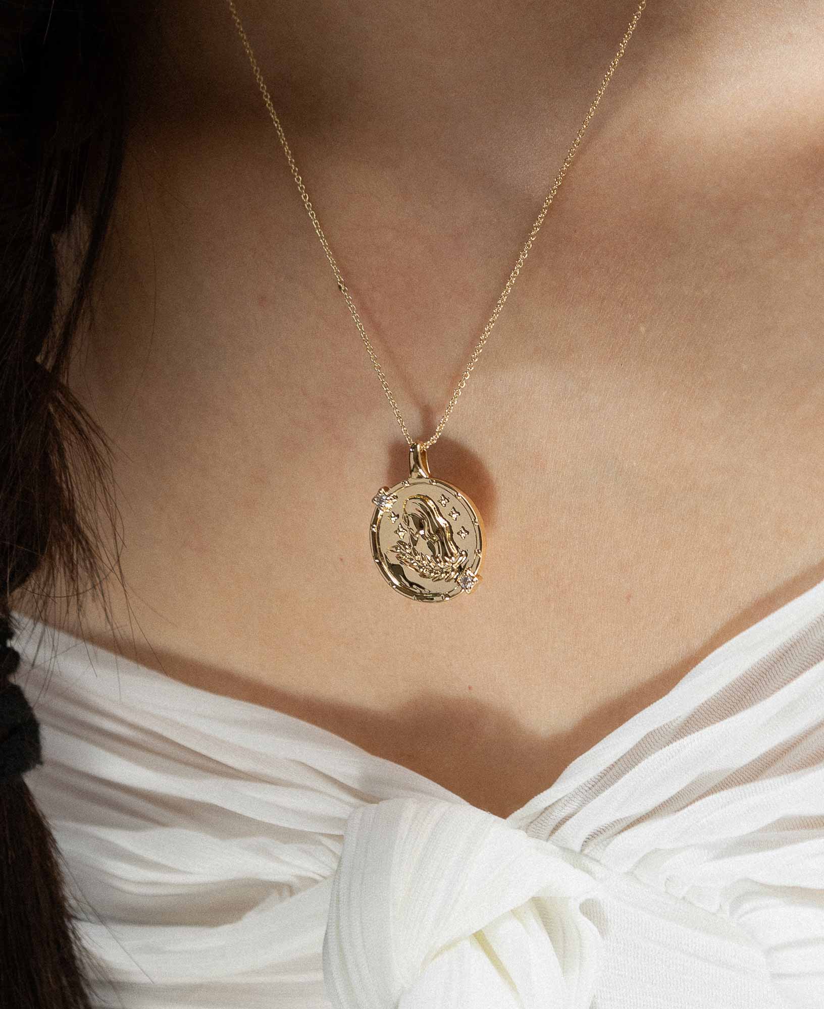 styling the virgo horoscope gold pendant necklace on a model.