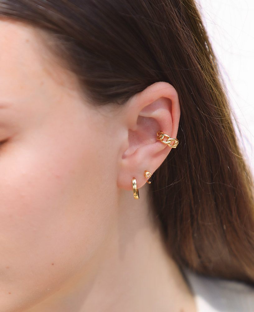 Model wearing simple earring stack featuring the lenette 14k gold chain ear cuff