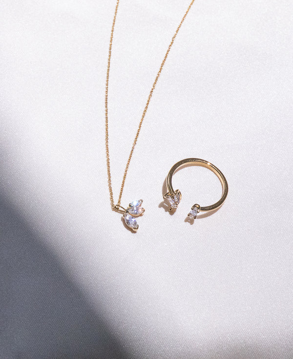 Outdoot flatlay shot of the Colette 14k gold necklace and camille 14k gold open ring - Sachelle Collective
