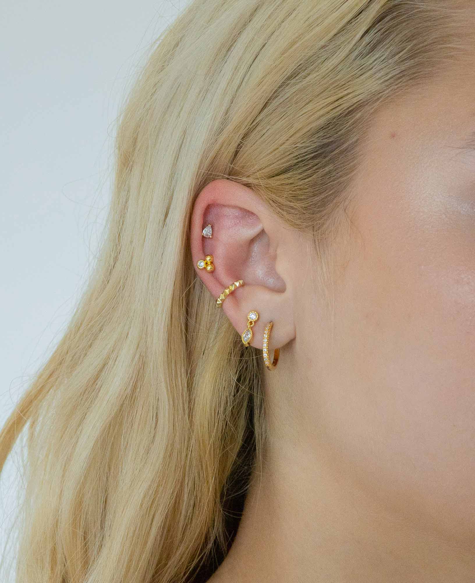 Model wearing Tilde 14k Gold Stud earring stack