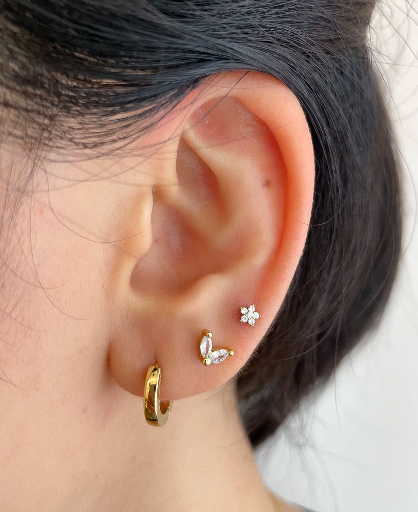 Lifestyle shot of model wearing Astrid CZ 14k Gold Stud Earring from Sachelle Collective, sustainable jewelry