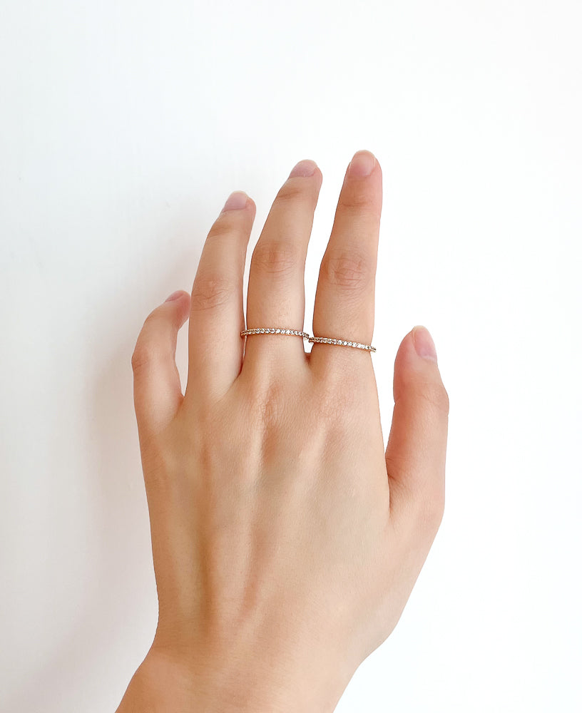 Jennifer Cubic zirconia classic dainty 14k gold eternity band ring lifestyle shot on hand - sachelle collective