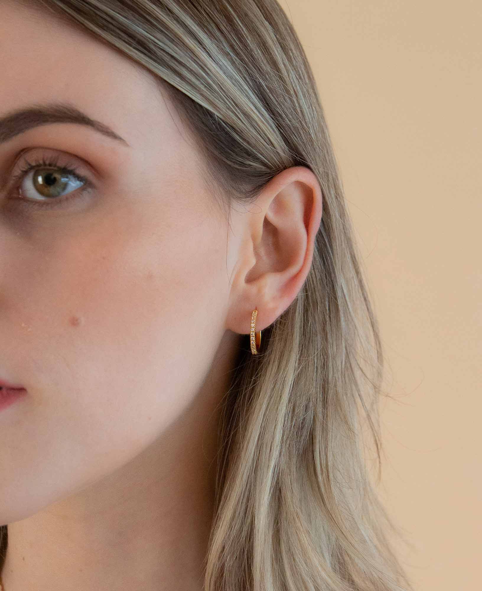 Model shot of dainty sparkly amelie classic CZ gold hoop earrings