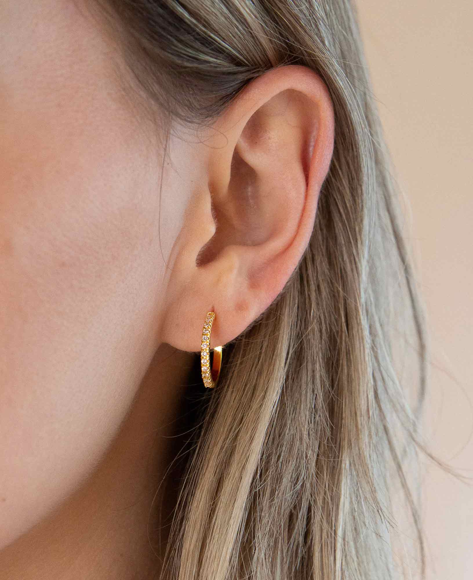 model wearing dainty sparkly amelie classic CZ gold hoop earrings