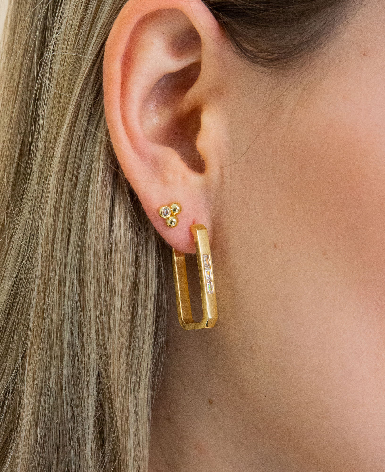 close up shot of model wearing Seva Rectangle Hoop earrings