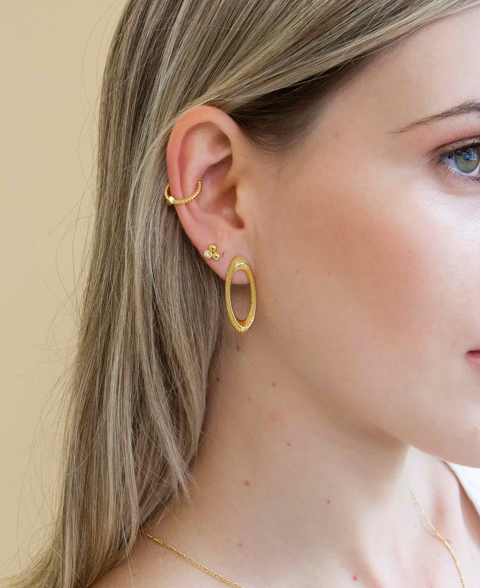 model wearing the tania oval 14k gold ribbed earrings