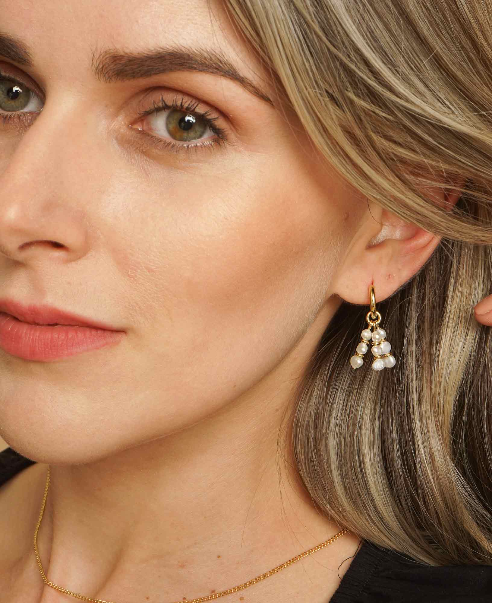 Model wearing the Ines Pearl Hoop Earrings