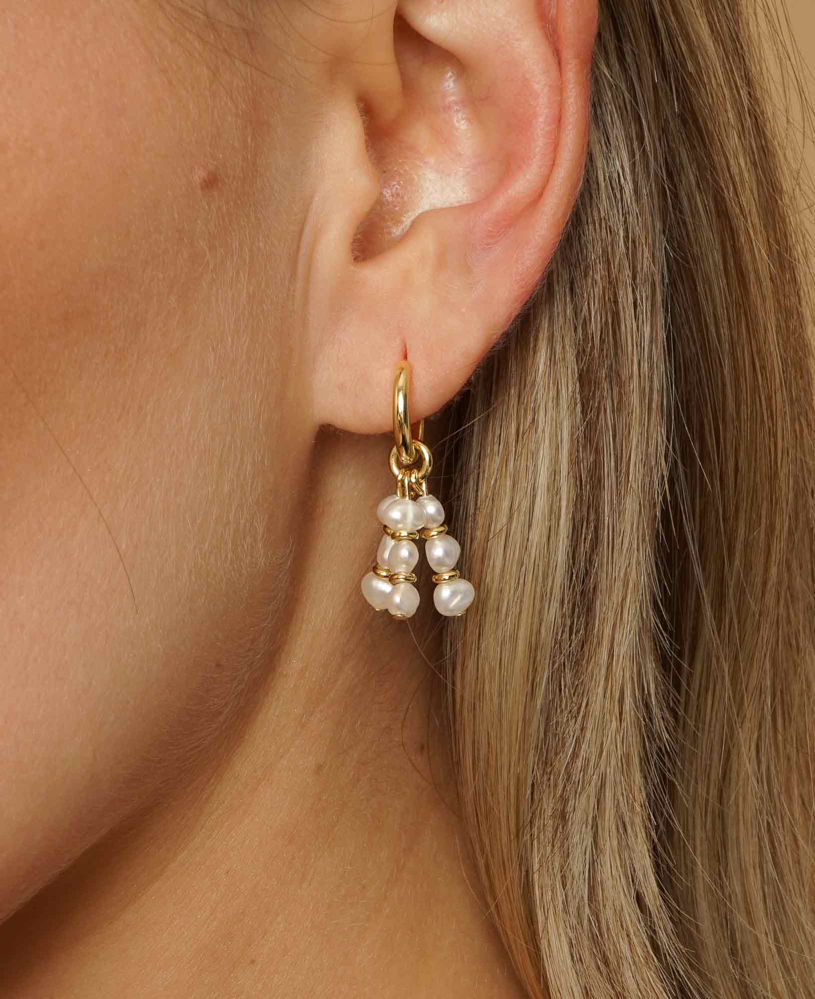 Close up shot of model wearing Ines pearl Hoop Earrings